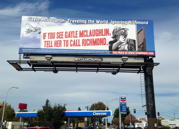 An anti-McLaughlin billboard, funded by Chevron, looms over San Pablo Avenue, criticizing her travel history. (Photo by: Brett Murphy)